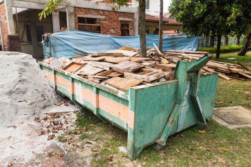 Workers managing builders waste removal