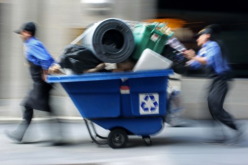 Charity volunteers collecting reusable furniture from a diverted skip load